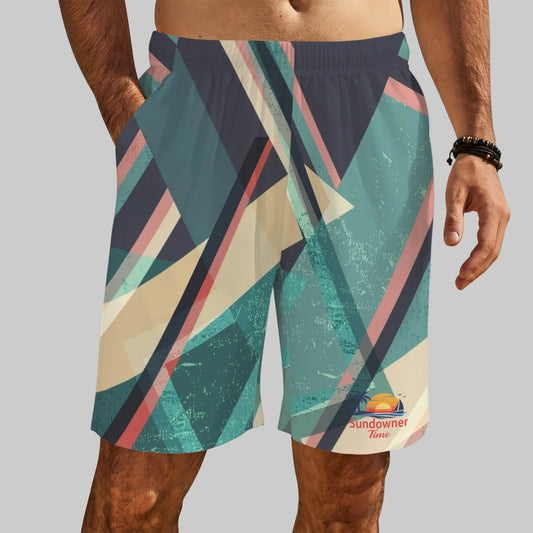 Men's athletic shorts with a colorful geometric pattern in teal, beige, pink, and navy, featuring a 'Sundowner Time' logo near the lower left hem, shown on a model.