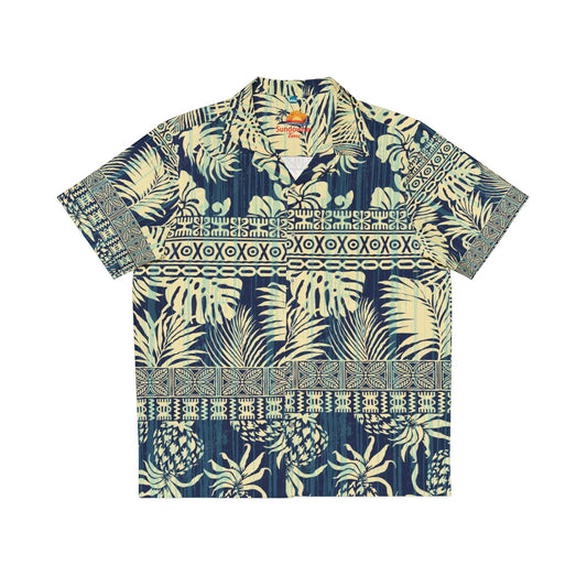 A short-sleeve camp collar button-up shirt with a tropical print featuring palm leaves, pineapples, and geometric tribal-style borders in navy blue and cream.