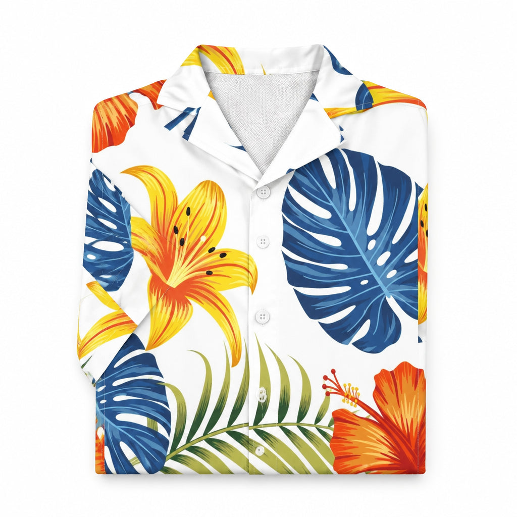 A short-sleeve button-up Hawaiian type shirt with a white base and a vibrant tropical print featuring blue monstera leaves, yellow and orange lilies, and green palm fronds.